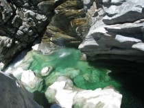 Emerald waters of The Maggia River flowing through a Swiss gorge  