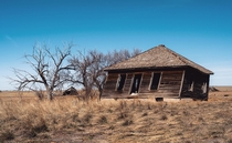 Farmhouse leaning into decades of wind Briggsdale Colorado 
