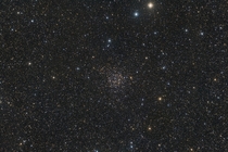 Found among the rich starfields of the Milky Way toward the constellation Cassiopeia star cluster NGC  lies about  light-years away A late th century deep sky discovery of astronomer Caroline Lucretia Herschel the cluster is also known as Carolines Rose 