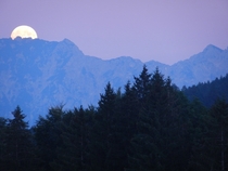 Full moon rising over the mountains in Wildhaus Switzerland  by Eliza Harris