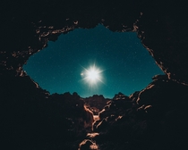 Full moon seen from a cave in Brfellsgj Iceland 