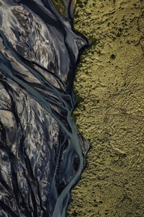 Glacial river meets moss covered lava - Iceland 
