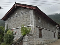 Grey brick house in a rural village in Yunnan China 