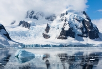 Having recently crossed the Drake Passage such a glassymirror ocean surface was stunning  Antarctic Peninsula coastline