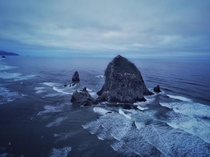 Haystack rock surrounded by ocean in Cannon Beach OR 