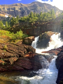 Hitchhiked  miles into the park on my day off to see if the legends of Many Glaciers beauty were true They were Red Rock Falls Glacier National Park Montana Bonus downstream view in comments 