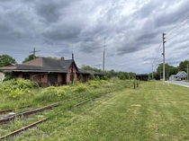 I posted some abandoned train tracks the other day this is the abandoned station they are connected to In the background you can see rows of abandoned cars theres dozens of them Years ago it serviced a gypsum loading facility on the nearby harbour Hantspo