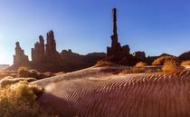 Icy dunes surrounding the Totem Pole located in Monument Valley Utah 