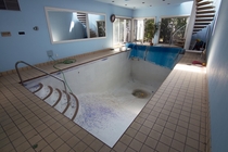 Indoor Pool in a vacant Ontario Canada house with overgrown yard