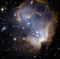 Inside star cluster NGC  a star-forming region in the Small Magellanic Cloud bright blue newly formed stars are blowing a cavity in this nebula-NASA