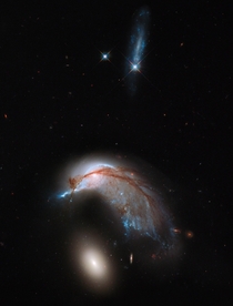 Interacting galaxies NGC  once a standard spiral galaxy and NGC  a smaller elliptical 