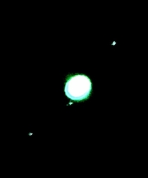 Jupiter and  moons through small telescope with blue filter