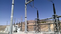 kV Electrical Transmission Substation reactors on left drop down into SF gas insulated conductors on right 