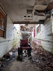 Lonely wheelchair in abandoned state hospital