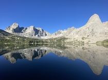 Lonesome Lake reflecting the Cirque of the Towers Wyoming Took this after sunrise on day  of my backpacking trip Absolutely stunning 