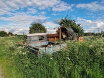 Long abandoned Land Rover Defender pickup and Thwaites Goliath dumper truck at abandoned farm