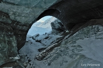 Looking at White Princess through an ice arch on the Castner Glacier in the Alaska Range 
