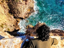 Looking down a cliff in Ibiza Spain 