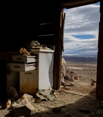 Looking out of an abandoned storehouse high in the Nevada mountains 