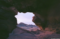 Looking through a natural hole in Aztec Sandstone at Nevadas Valley of Fire State Park 
