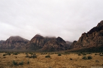 Low hanging clouds over the mountains in Nevadas Red Rock National Conservation Area 