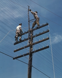 Men working on telephone lines probably near a TVA dam hydroelectric plant  June 