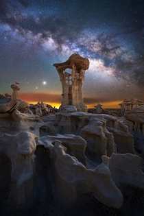 Milky Way Jupiter and Saturn captured over otherworldly rock formations located in a remote part of New Mexico 