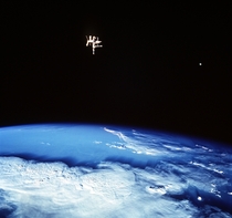 Mir and the Moon while orbiting the planet during their June  mission the crew of the Space Shuttle Discovery photographed this view of two satellites of the Earth 