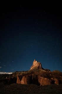 Moon lighting up desert spire Escalante Utah 