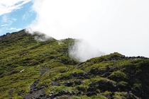Mount Etna being eaten away by a cloud 