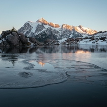 Mount Shuksan reflecting in an icy tarn Washington 