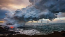 Multiple waterspouts touching down where the lava flow meets the ocean at Kilauea 