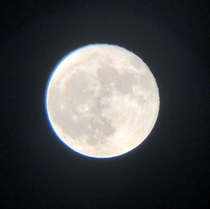 My first ever decent picture of the moon even if it is low quality Does anybody know what the blue ring on the left side is