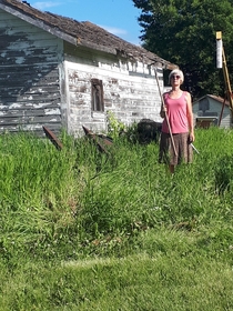 My mom posing s style infront of her grandmothers abandoned home