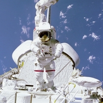 NASA astronaut Bruce McCandless walking above space shuttle payload bay 