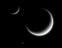 NASAs Cassini spacecraft has captured a rare family photo of three of Saturns moons Titan Mimas and Rhea 