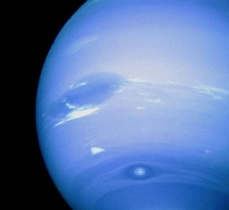Neptunes Great Dark Spot accompanied by white high altitude clouds