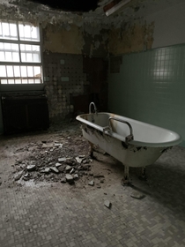 Old bathtub in abandoned mental hospital