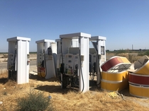 Old Gas Pumps Abandoned In Field