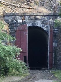 Old railroad tunnel in Montana  Over a mile long straight through a mountain That speck of light you see Thats the other end