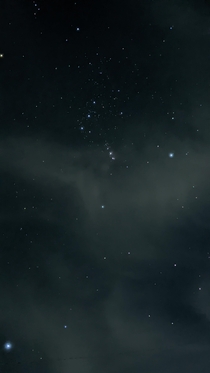 Orion standing on clouds