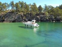 Our boat floating on clear water at Djknesundet Lake Vttern Sweden 