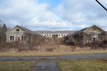 Overgrown hospital building at abandoned childrens insane asylum Video of exploration up on my YouTube Deadline Urbex