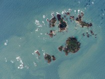 Parallel swells from the open ocean are radiated around the islets and shallow areas of the Isles of Scilly UK Photo taken from the ISS Largest island is xkm   