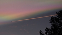 Polar stratospheric cloud with a plane
