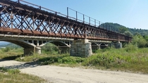 Rail Viaduct built in  now abandoned Doftana Romania Next to it road bridge built in  still in use