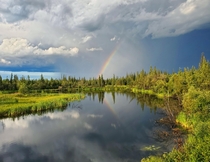Rainbow over pond near Behchoko NWT Canada 