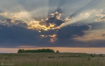 Rays of sunlight burst through rain clouds over Grey Sand Dunes Natural Area in Minnesota 