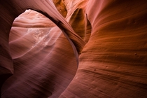 Red sandstone sculpted by wind and sand to look like a muscle in Antelope Canyon 