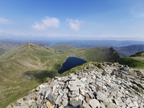 Red Tarn and Striding Edge from Hellvelyn with Ullswater in the background Lake District UK 